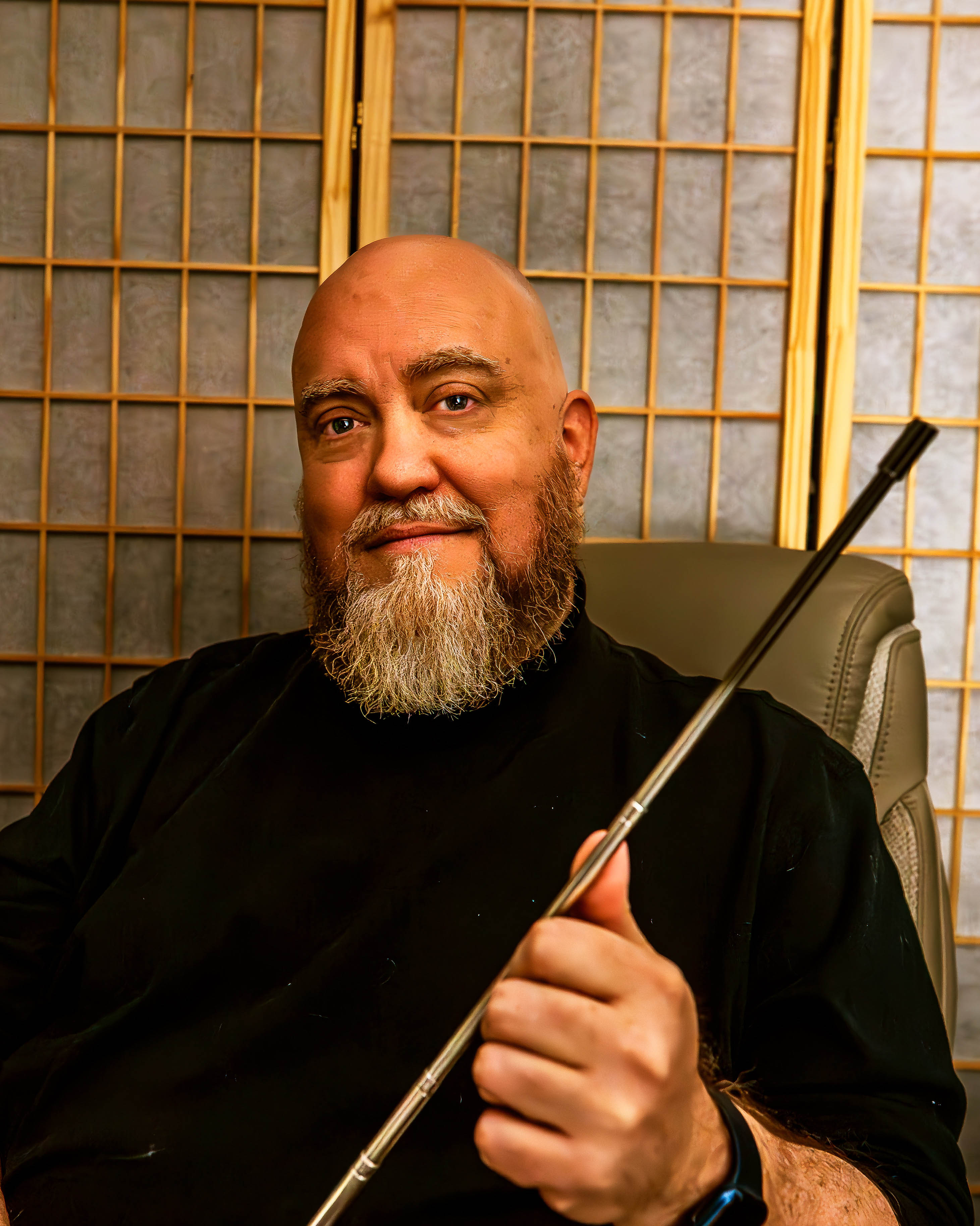 Man with beard holding a rod