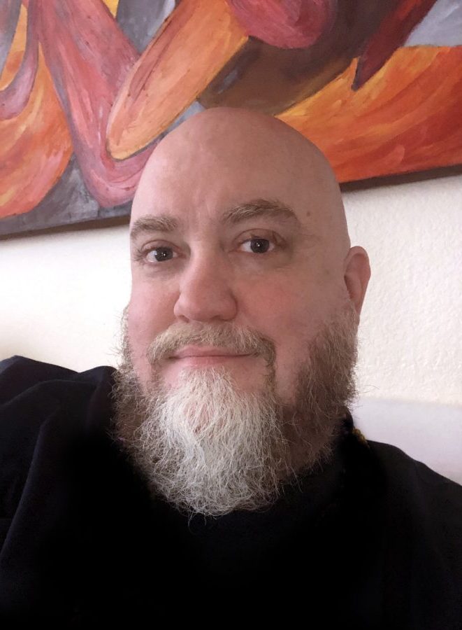 Man with beard smiling at camera