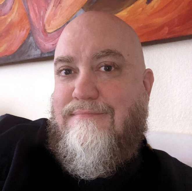 Jason sitting next to a red painting